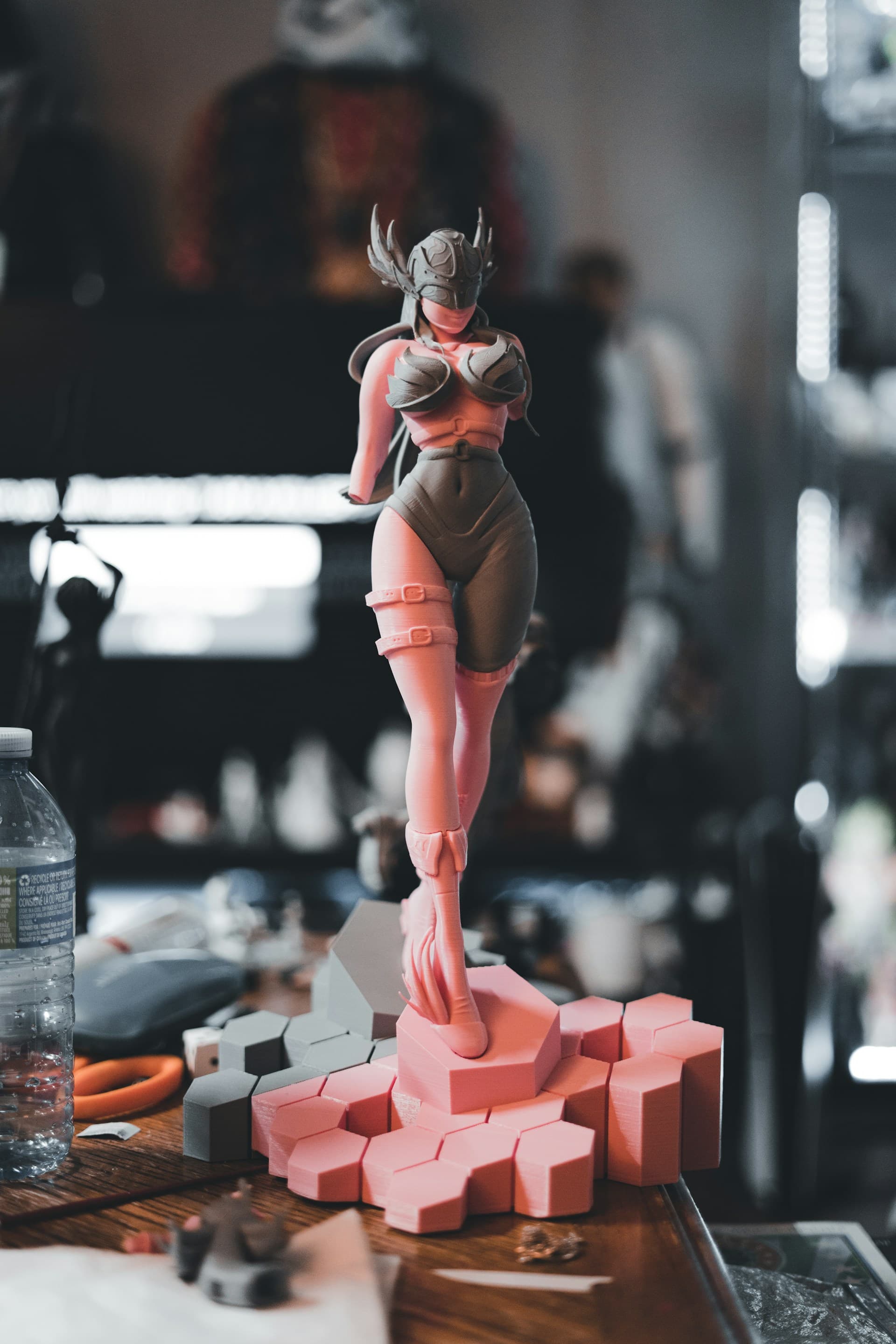 Unpainted two-tone resin 3D print of a character figure standing on its support raft