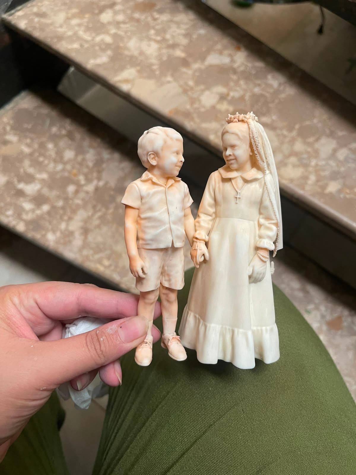Unpainted 3D printed figurine of two children before hand-finishing