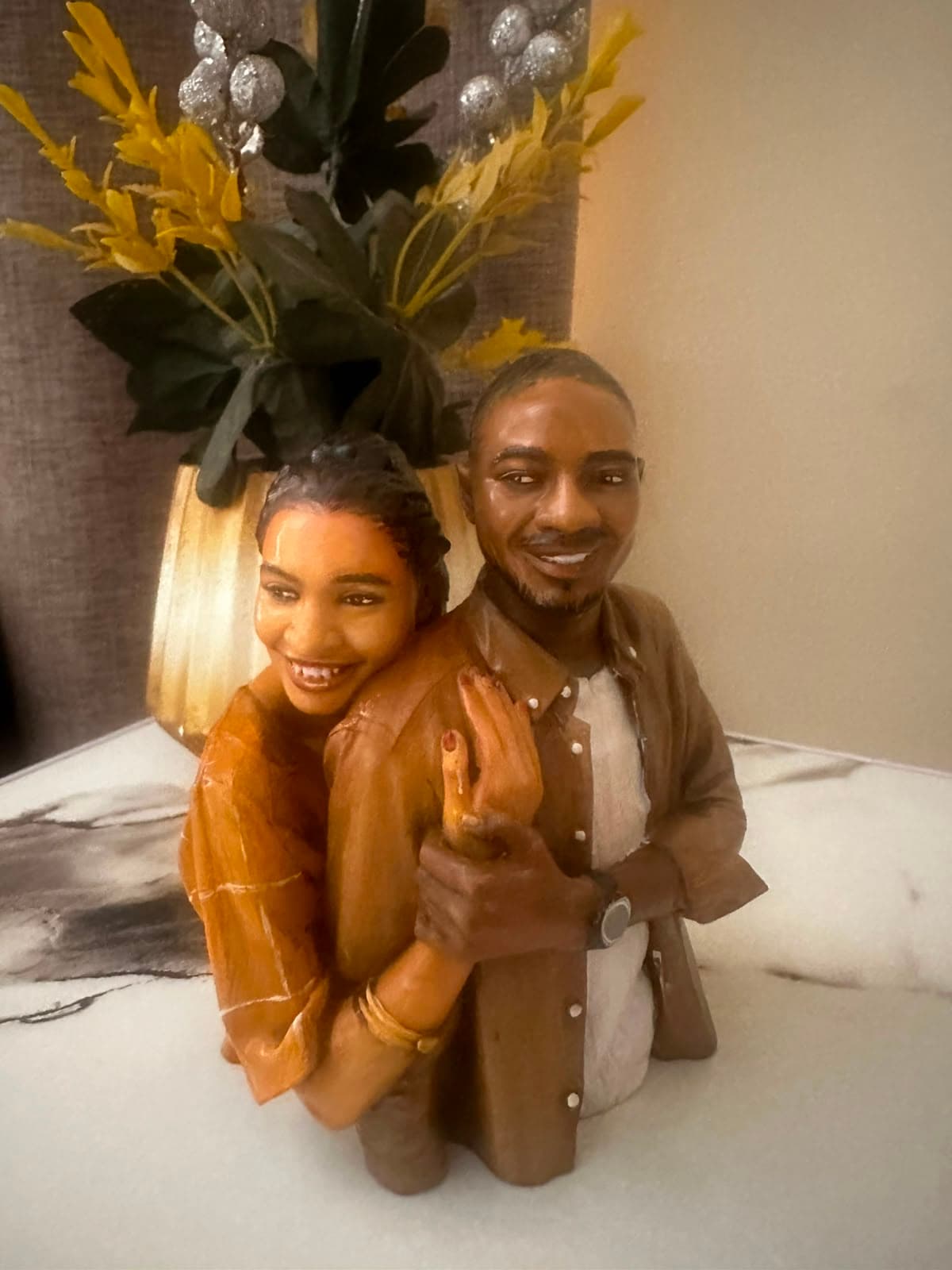 Custom couple figurine displayed on a side table at home